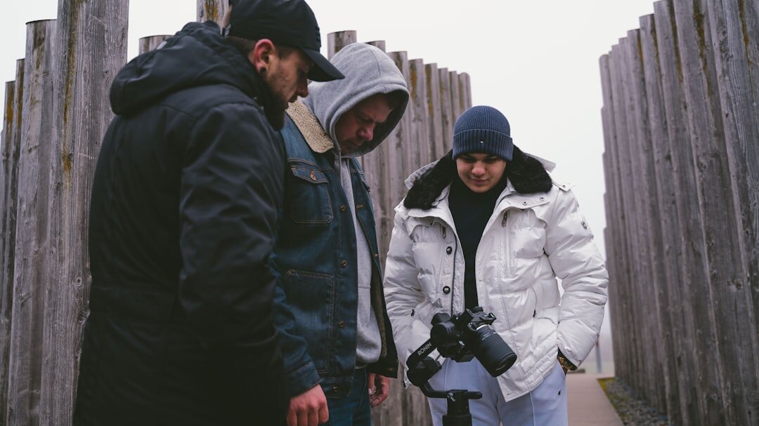 Team of three Danish documentary photographers reviewing photos together