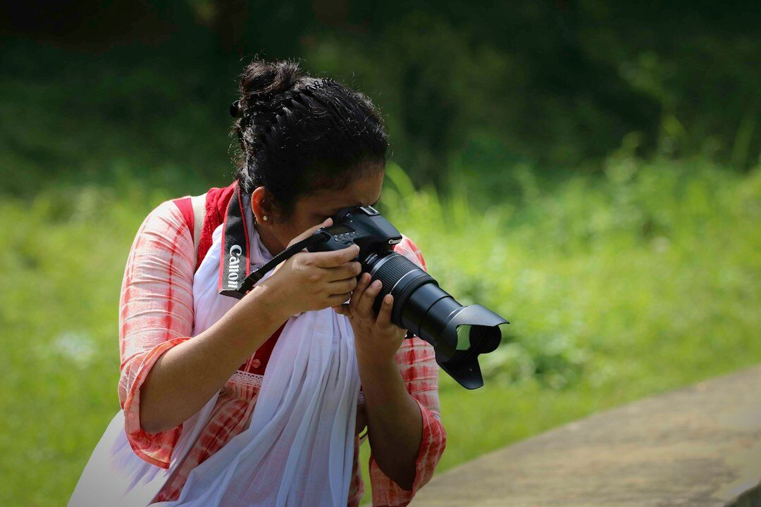 Portrait of a Danish female documentary photographer holding a camera
