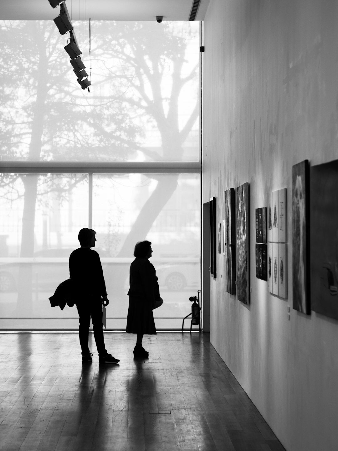Visitors viewing framed documentary photographs in a gallery exhibition