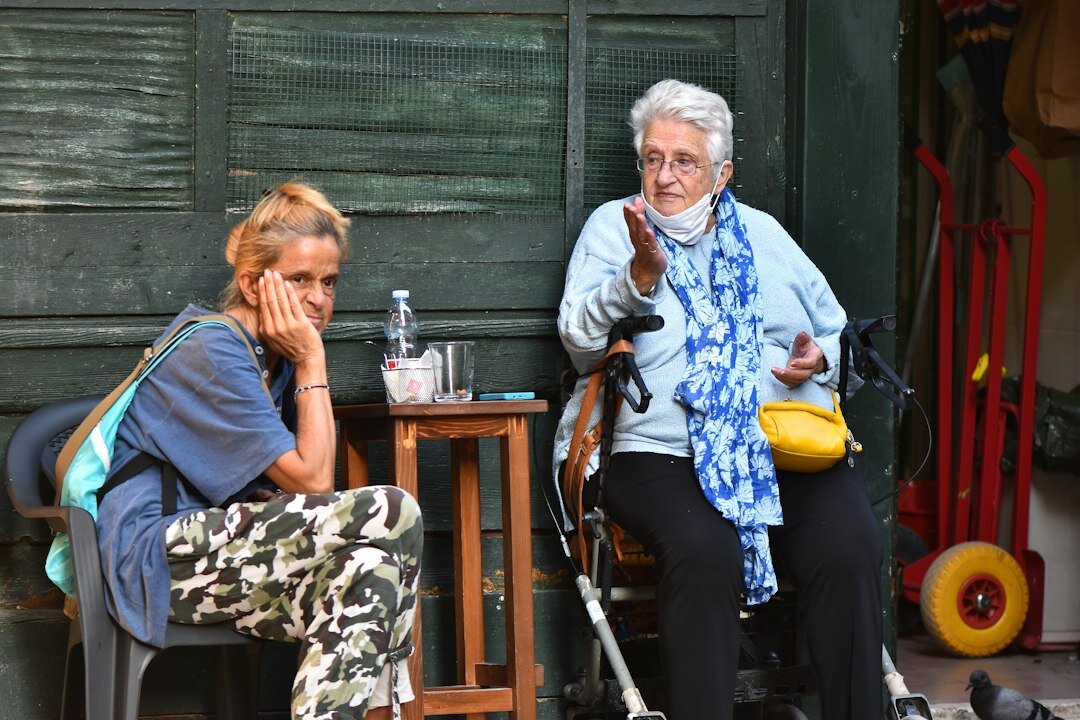 Photographer interviewing an elderly woman in her living room in Denmark